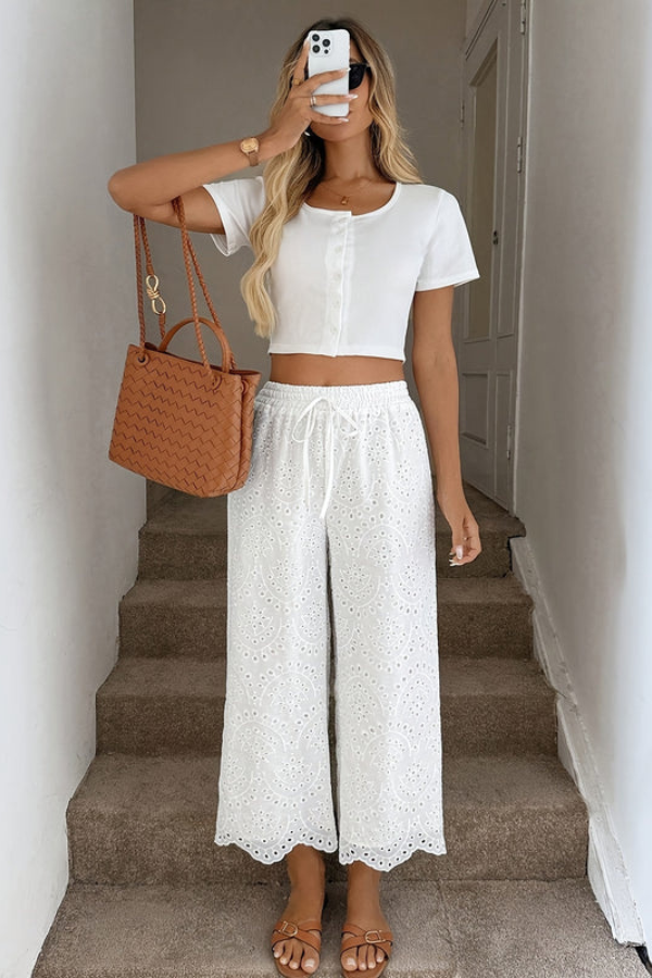 Lightweight boho chic capri pants for women with eyelet design, ideal for summer beachwear & everyday comfort.
