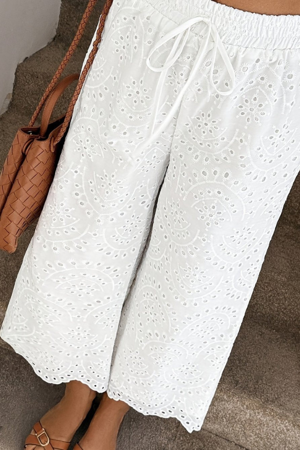 Women's summer cropped pants featuring an intricate eyelet design, offering boho chic style & lightweight comfort.