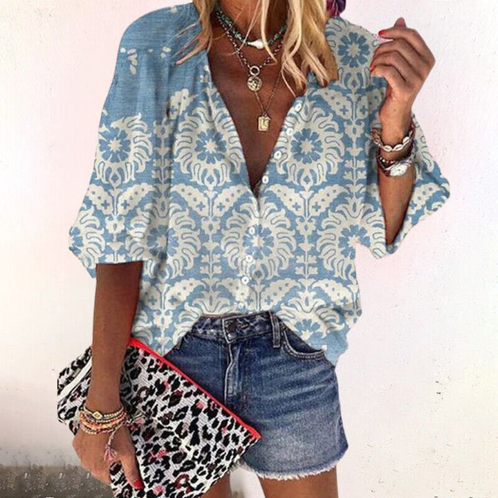 Bohemian women's short sleeve floral blouse with V-neck & button front. A versatile top for trendy spring/summer looks.