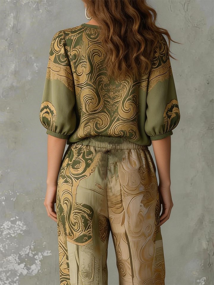 Model wearing women's bohemian print two-piece summer outfit: V-neck half-sleeve top & relaxed fit pants.