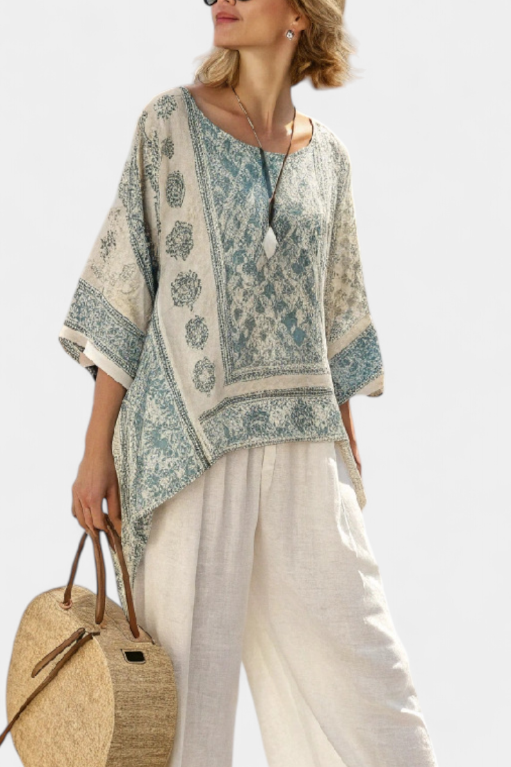 Relaxed fit women's two-piece set with vibrant floral print, batwing blouse, and comfortable wide-leg pants.