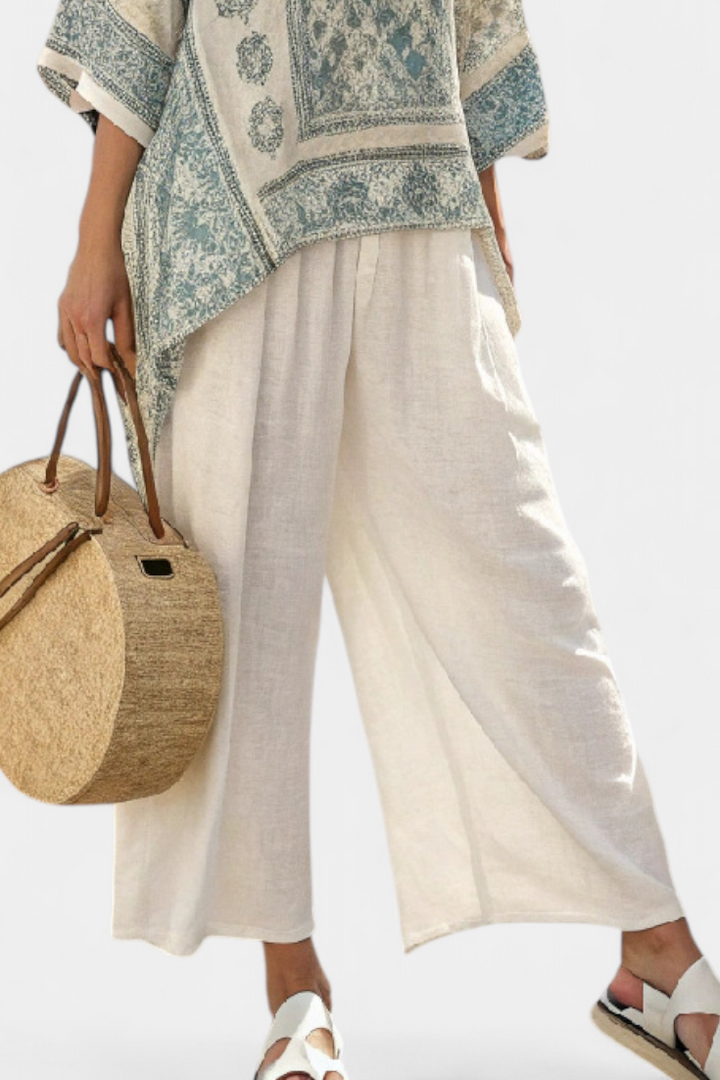 Boho women's set featuring a printed batwing blouse and elastic waist wide-leg pants, ideal for summer fashion.