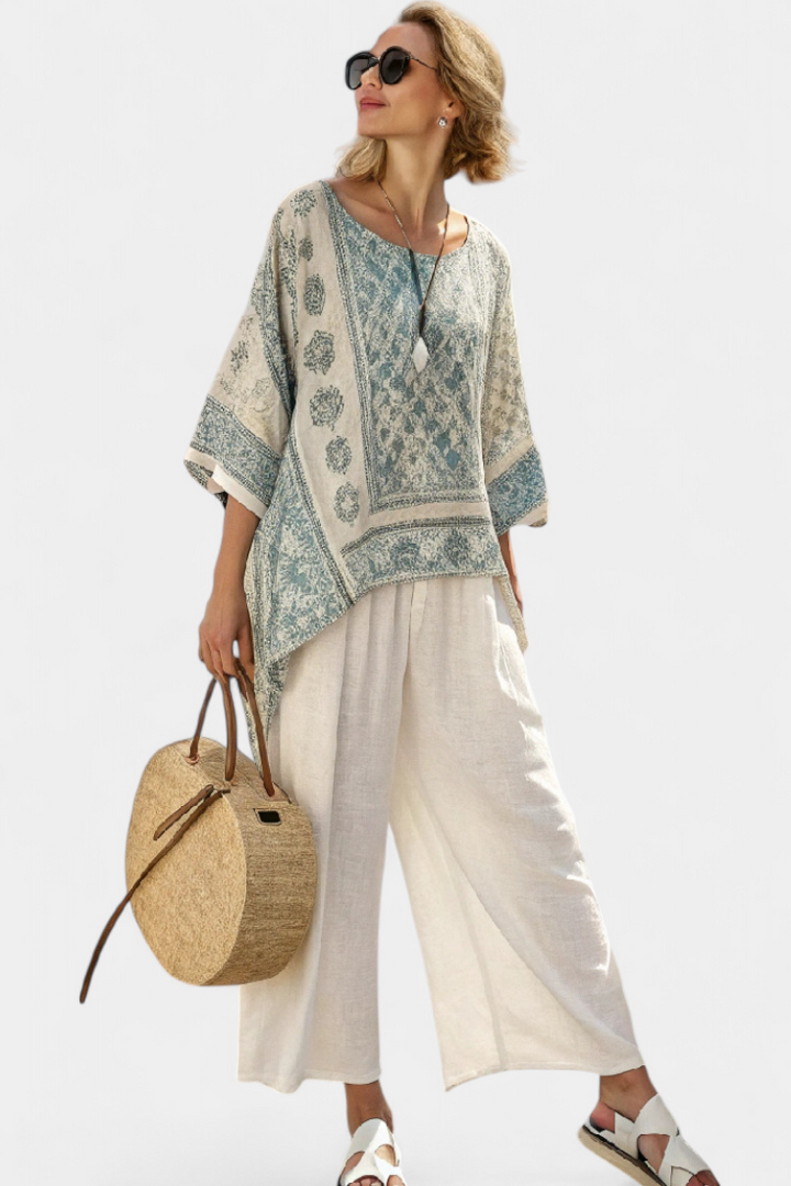Stylish women's boho outfit: floral batwing blouse & wide-leg pants. Perfect casual chic two-piece for vacation wear.