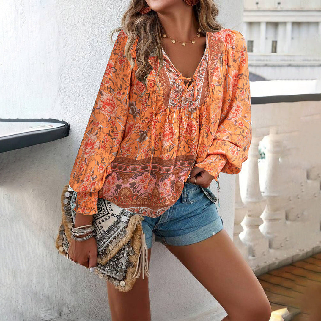 Bohemian women's blouse with bright floral print, loose fit, V-neck, and trendy puff sleeves for summer.