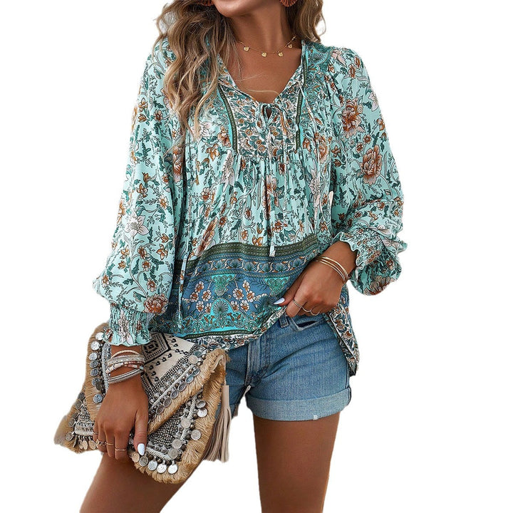 Loose women's floral boho blouse with V-neck, puff sleeves, perfect for casual summer days or vacation style.