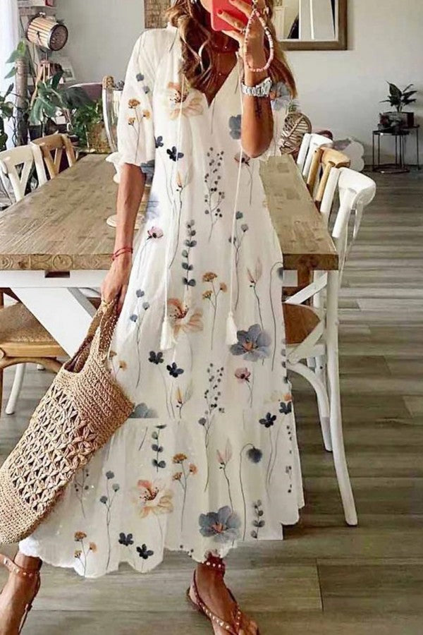 Women's boho floral V-neck maxi dress with tassel detail, perfect for summer vacations.