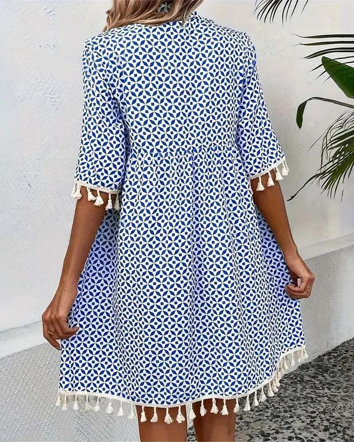 Printed women's casual mini dress with stylish tassel trim & short sleeves. A must-have boho day dress.