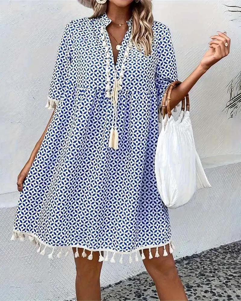 Effortless relaxed fit women's mini dress with tassel trim & V-neck. Comfortable short sleeve summer dress.
