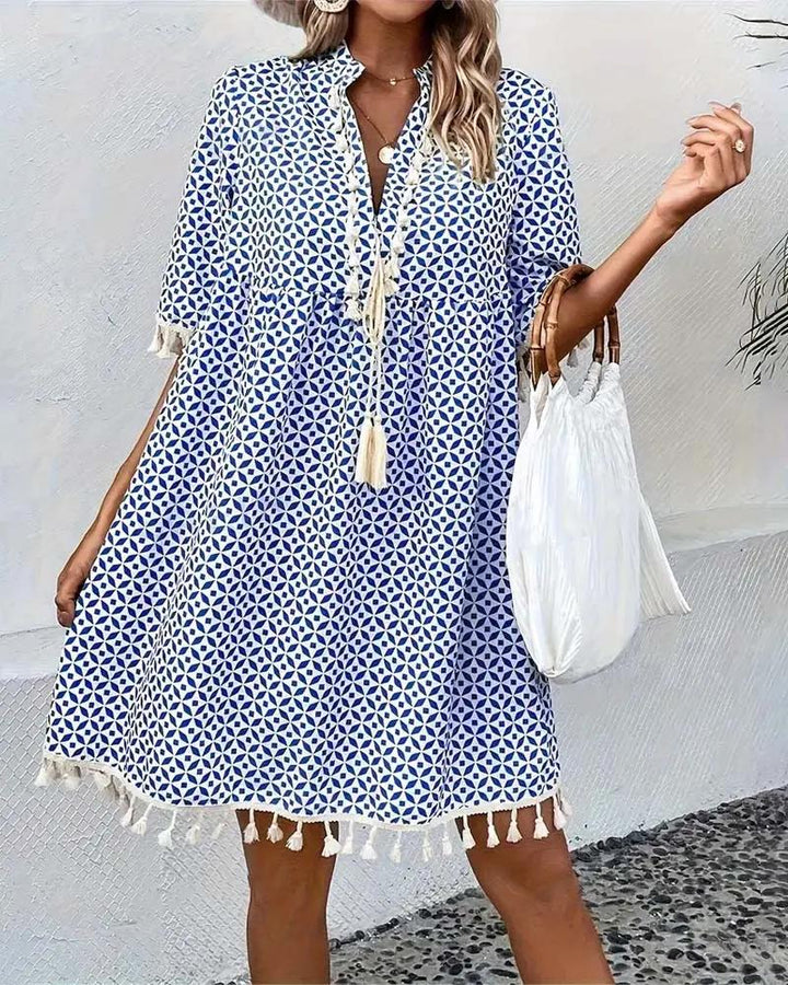 Effortless relaxed fit women's mini dress with tassel trim & V-neck. Comfortable short sleeve summer dress.