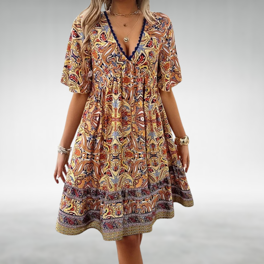 Women's boho paisley print mini dress with short sleeves. Vibrant summer casual wear, perfect for vacation.