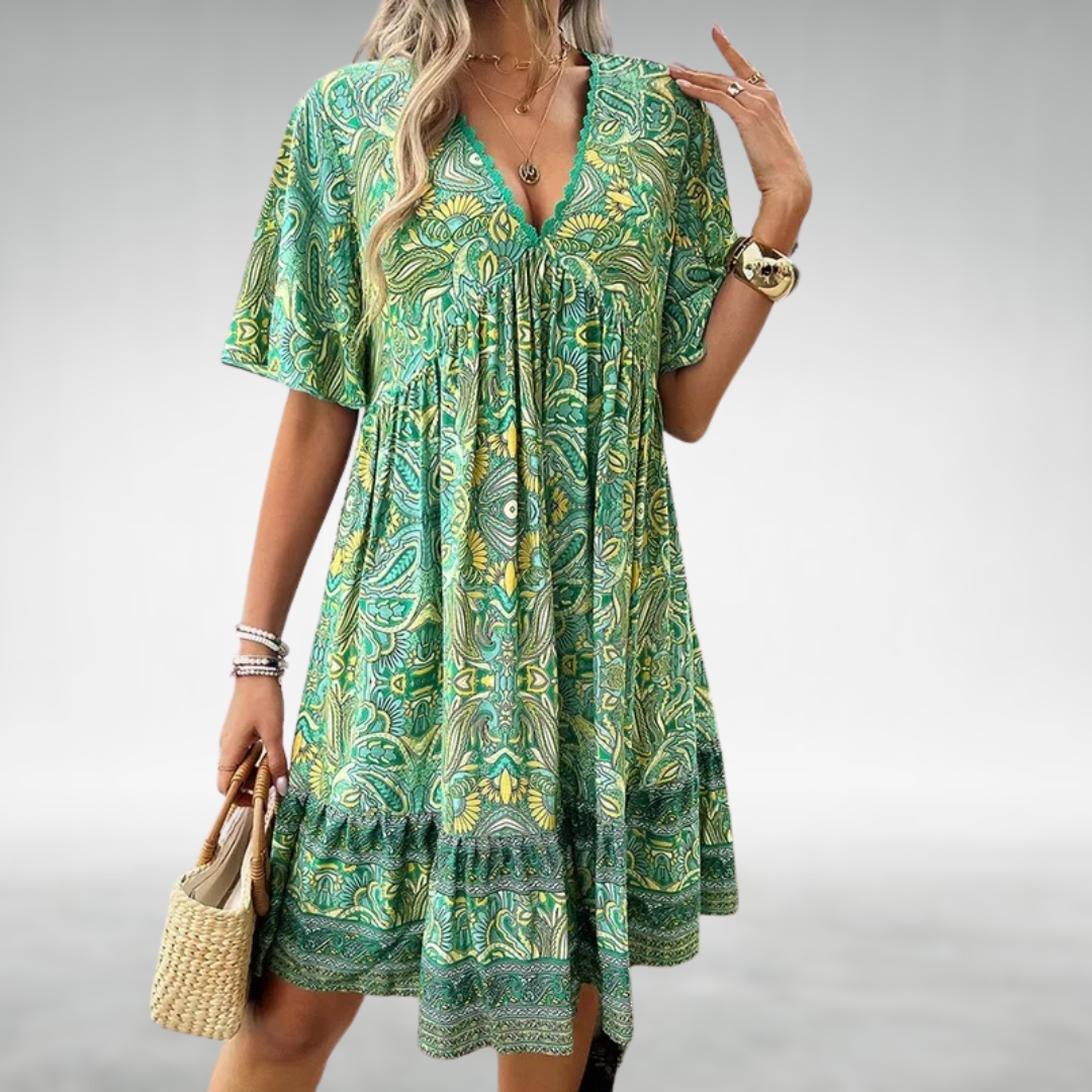 Flowy boho paisley print mini dress for women. Vibrant short sleeve summer style, ideal for casual outings & vacations.