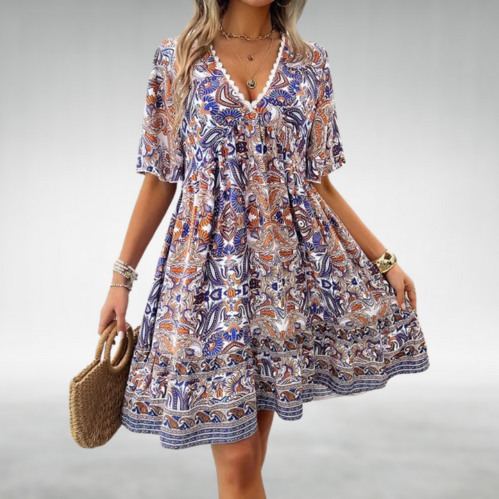 Stylish women's short sleeve mini dress featuring a colorful boho paisley print. A comfortable & vibrant summer vacation outfit.