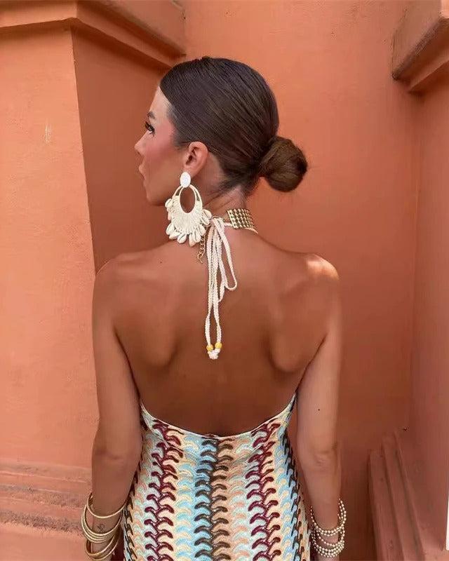 Close-up of beige multi printed boho maxi dress fabric, showcasing the intricate V-neck design.