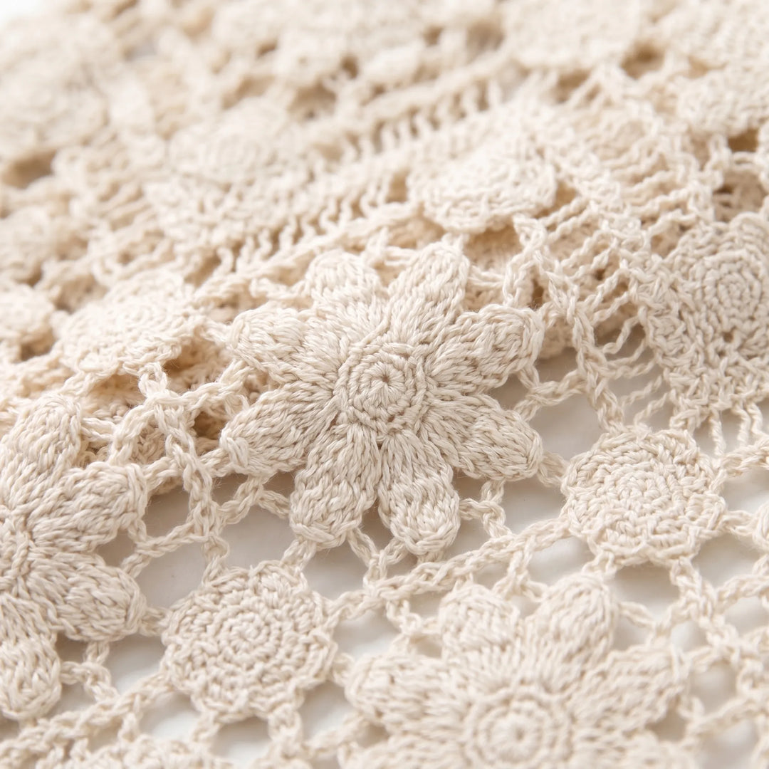Close-up of a women's knit boho vest featuring a sleeveless v-neck design and intricate summer floral pattern.