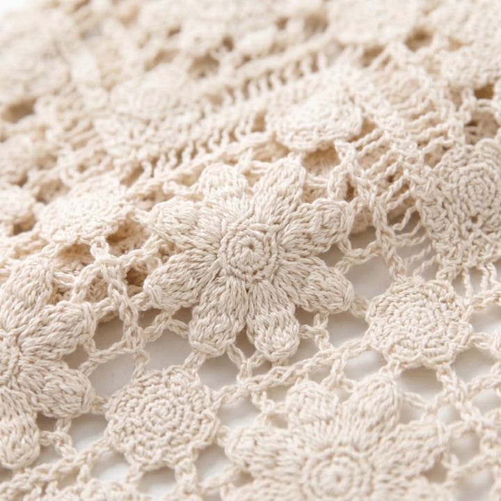 Close-up of a women's knit boho vest featuring a sleeveless v-neck design and intricate summer floral pattern.