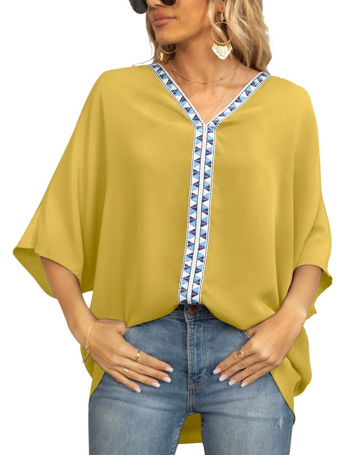 Flowy women's boho top, V-neckline with geometric trim, half sleeves, comfortable for spring/summer.