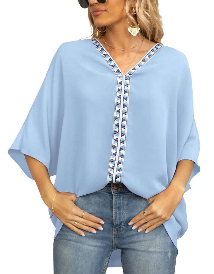 Stylish women's bohemian tunic, geometric V-neck detail, oversized fit, comfortable half-sleeve blouse.