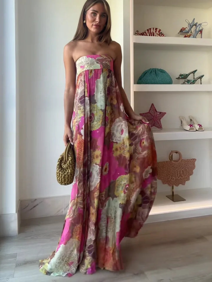 Elegant flowy strapless maxi dress for women, featuring a vibrant bold floral print & empire waist.