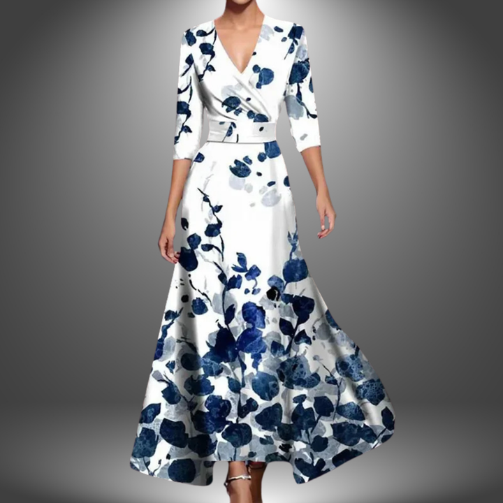 Bold floral print women's wrap maxi dress. Features a V-neck, three-quarter sleeves, and a graceful flowy silhouette.