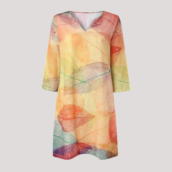 Elegant women's midi dress with vibrant botanical print, featuring a V-neck and pockets for summer fashion.