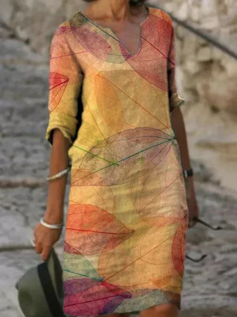 Flowy women's botanical print midi dress, V-neck design, with practical pockets, ideal for effortless summer style.