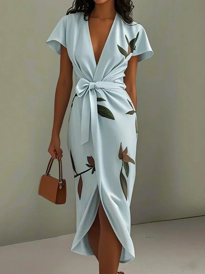 Stunning printed midi wedding guest dress for women, featuring a chic V-neck, wrap style, and vibrant botanical print.