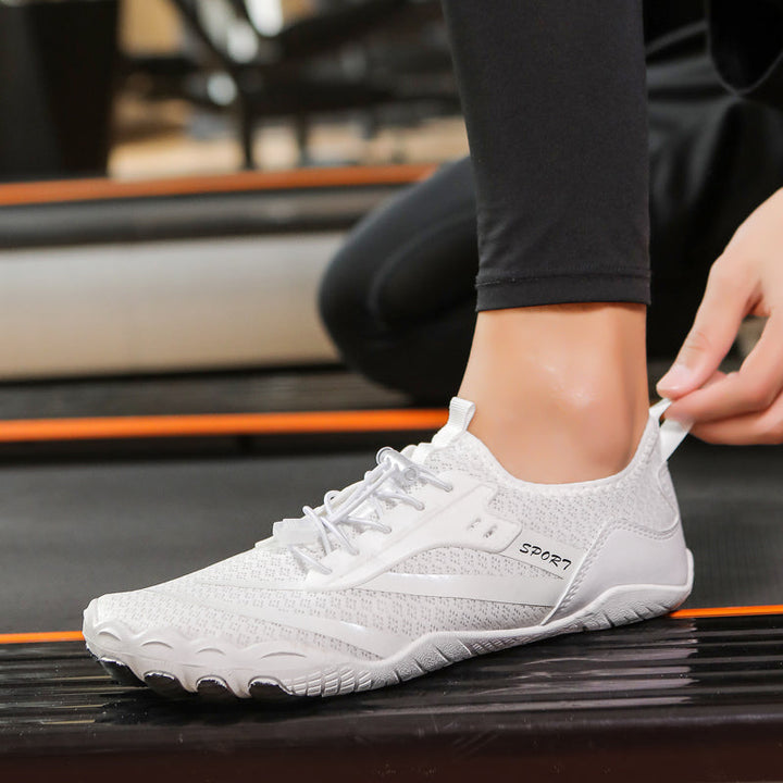 Side profile of women's zero-drop athletic footwear. Flexible sole for enhanced ground feel & active lifestyle.