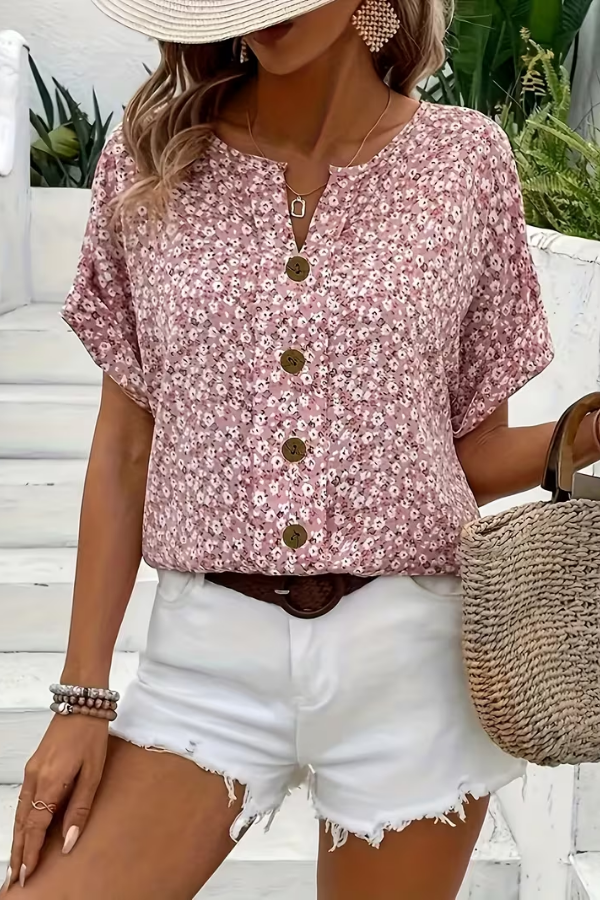 Women's breezy floral blouse for summer. Lightweight, short-sleeve top with relaxed fit, perfect for casual elegance.