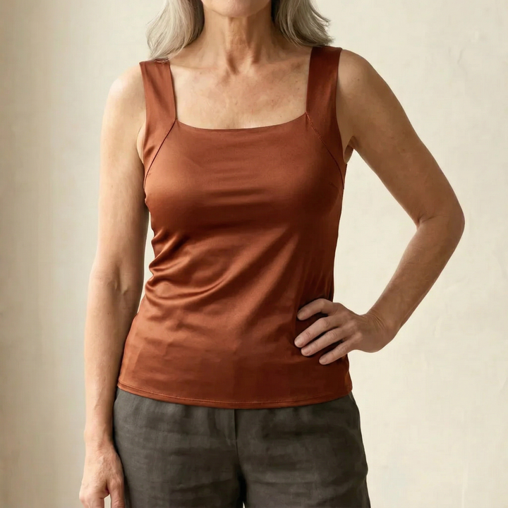 Flattering women's tank top with built-in bra, versatile for everyday and activewear comfort.