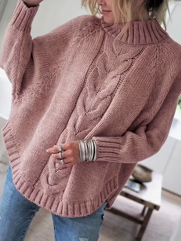 Women's cable knit high-neck sweater with flared hem, perfect for cozy fall fashion.