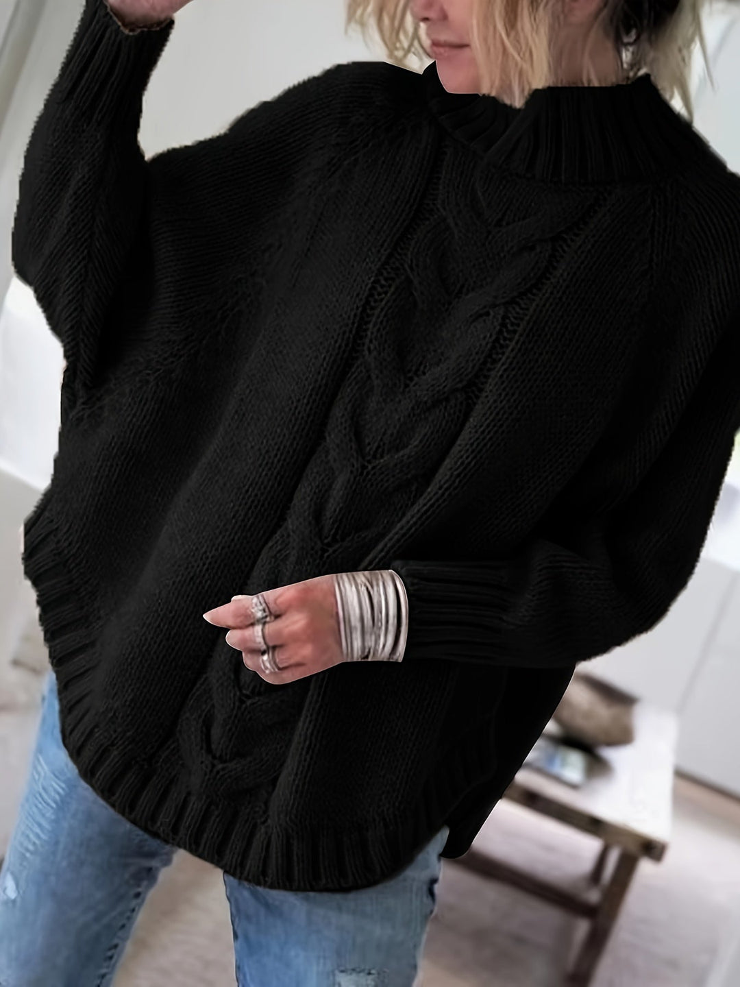 Chic women's cable knit high-neck sweater with a flared hem for stylish fall comfort.