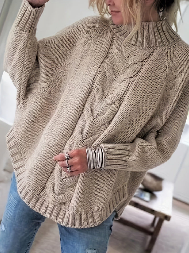 Comfortable batwing sleeve cable knit high-neck sweater with flared hem for fall women's wear.