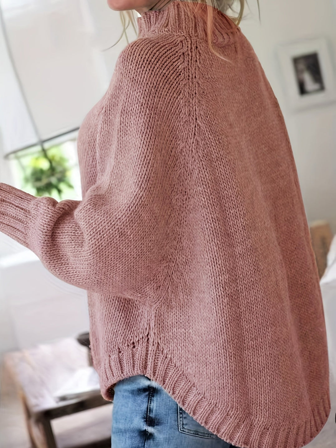 Women's cozy high-neck cable knit sweater featuring a stylish flared hem for fall and winter.
