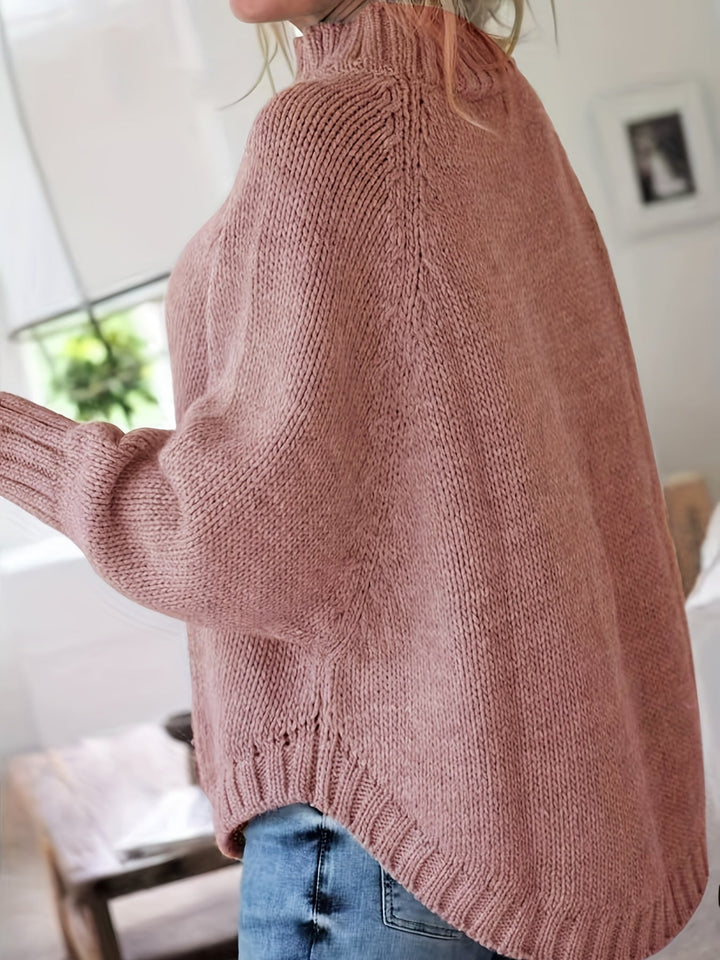 Women's cozy high-neck cable knit sweater featuring a stylish flared hem for fall and winter.