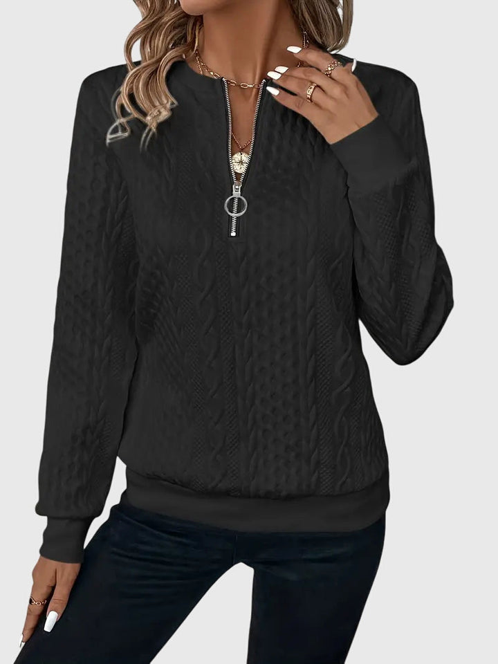 Classic women's cable knit quarter-zip sweater, a timeless piece of warm winter knitwear.