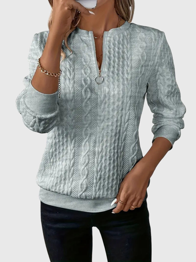 Chic women's cable knit quarter-zip sweater, a versatile pullover for fall/winter layering.