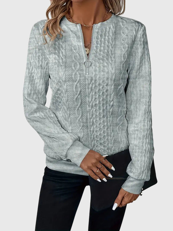 Relaxed fit women's cable knit quarter-zip pullover, ultimate cozy comfort in knitwear.