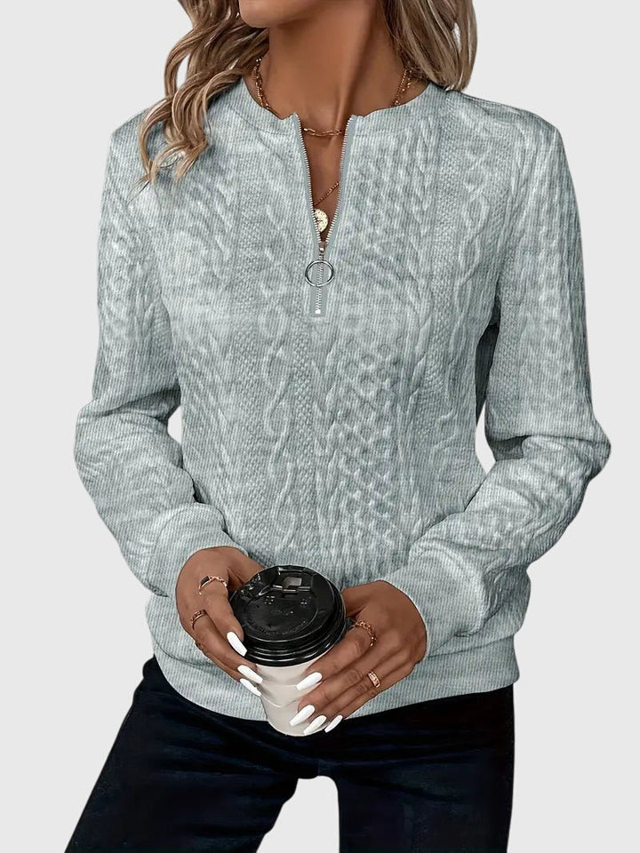 Durable women's cable knit quarter-zip sweater, a high-quality textured pullover for women.