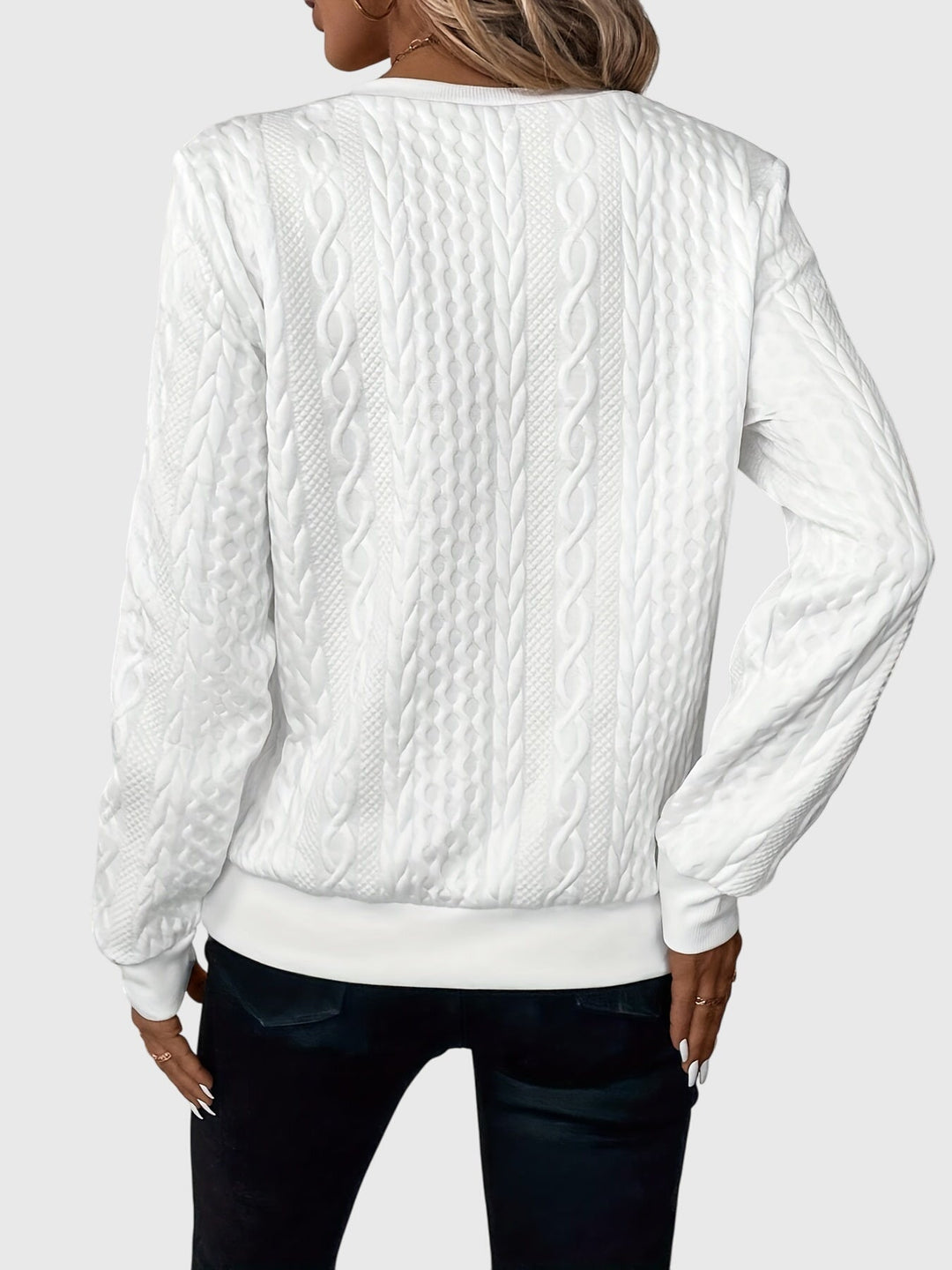 Stylish women's cable knit quarter-zip pullover, a textured long sleeve knitwear piece.