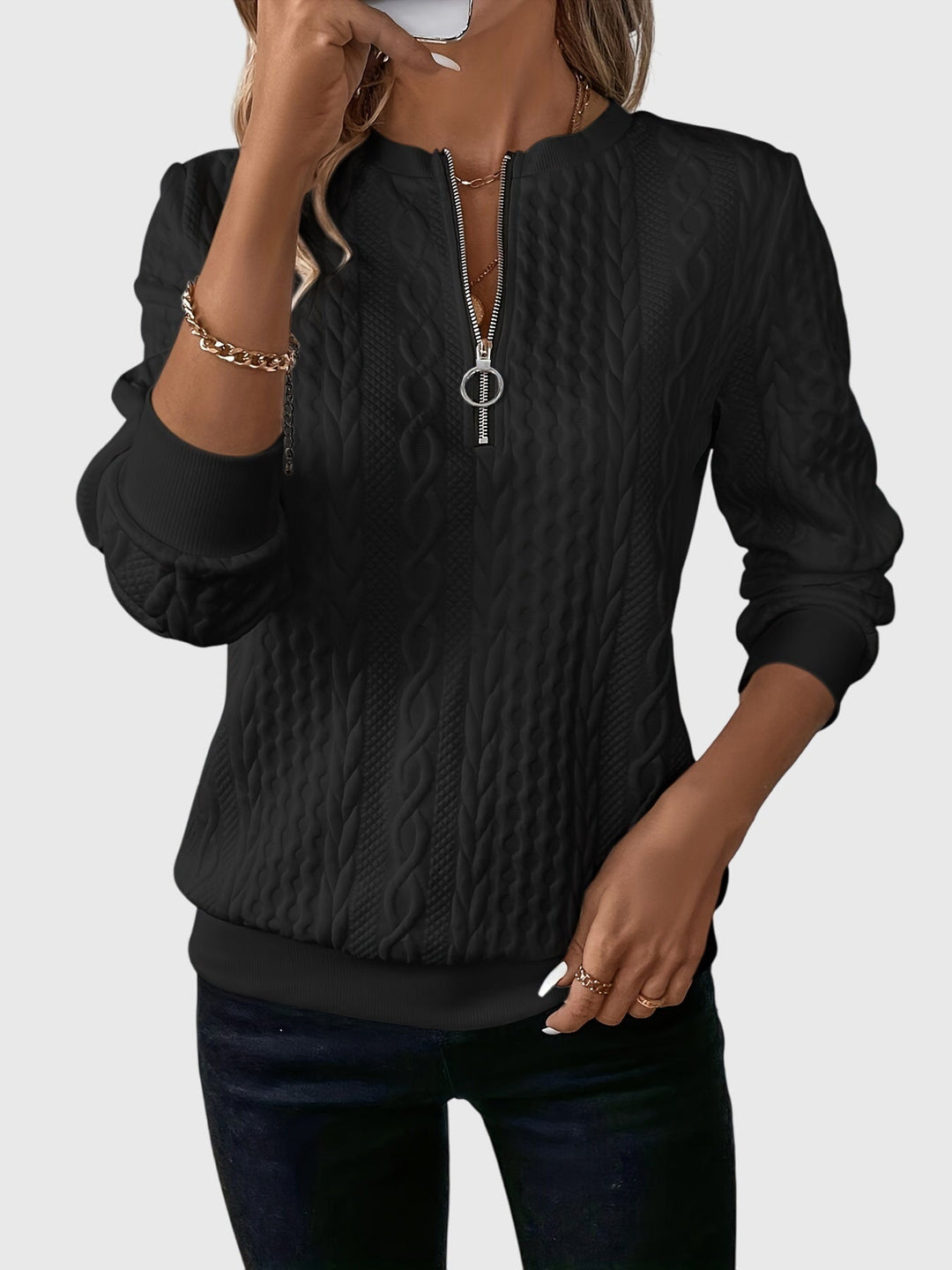 Elegant women's cable knit quarter-zip sweater, perfect for versatile fall fashion.