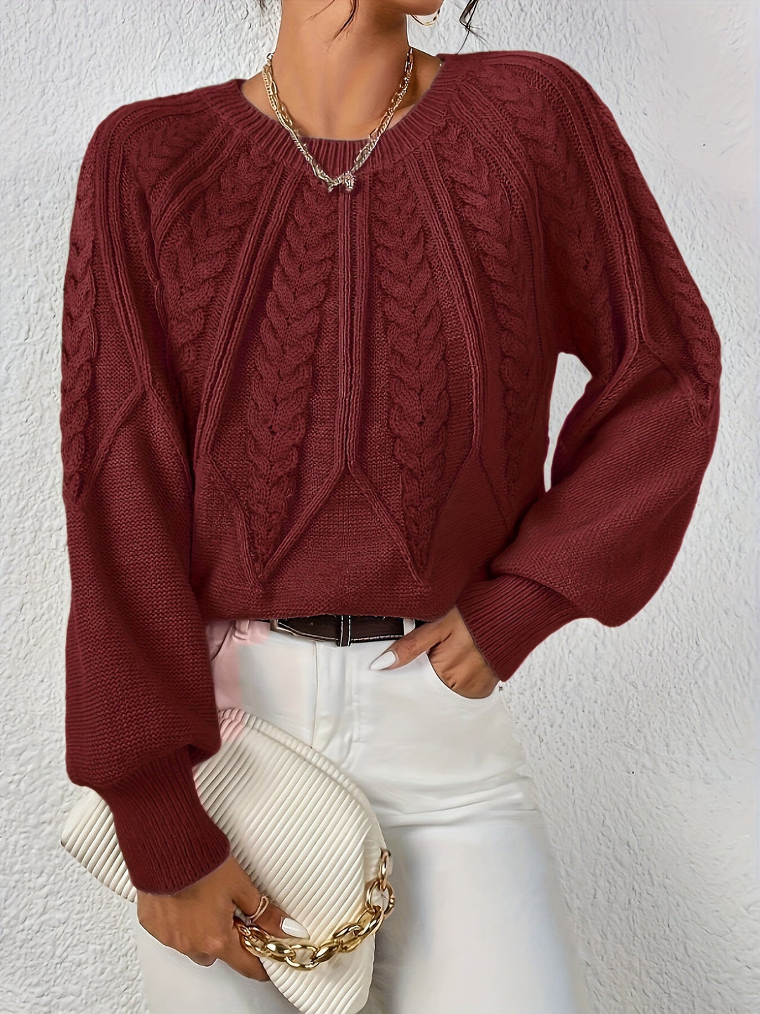 Chic women's cable knit sweater, relaxed fit, statement lantern sleeves, perfect for cozy winter.