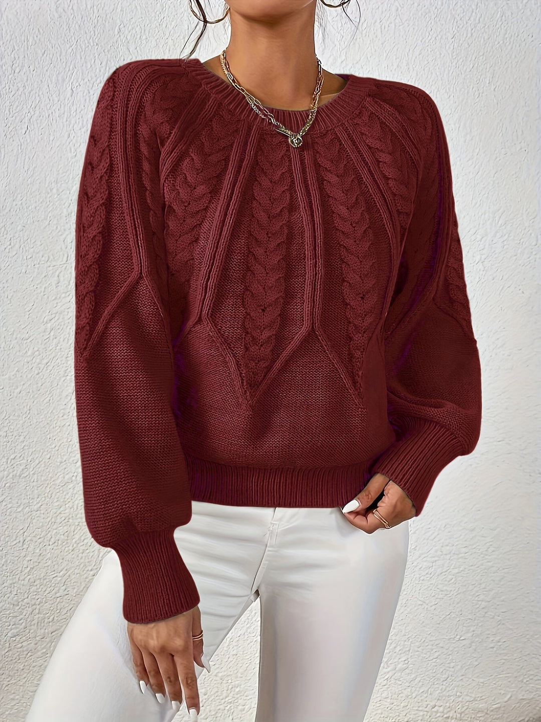 Trendy women's cable knit sweater, relaxed fit, oversized lantern sleeves, ideal for layering.