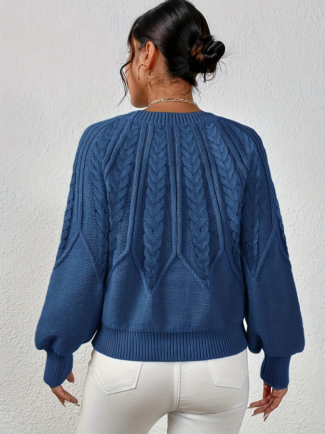 Soft women's cable knit sweater, relaxed fit, cozy lantern sleeves for ultimate comfort.