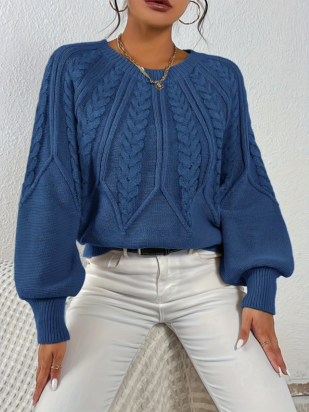 Elegant women's relaxed fit cable knit sweater, featuring stylish lantern sleeves & rich texture.