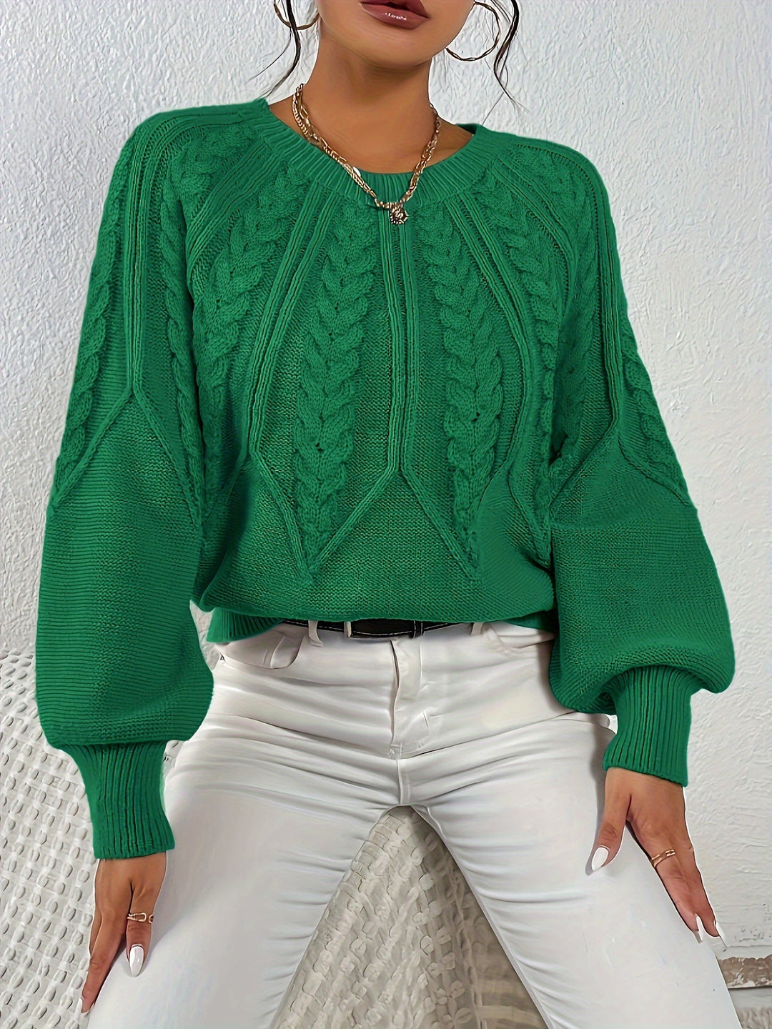 Relaxed fit women's cable knit sweater, stylish lantern sleeves, great for chilly days.