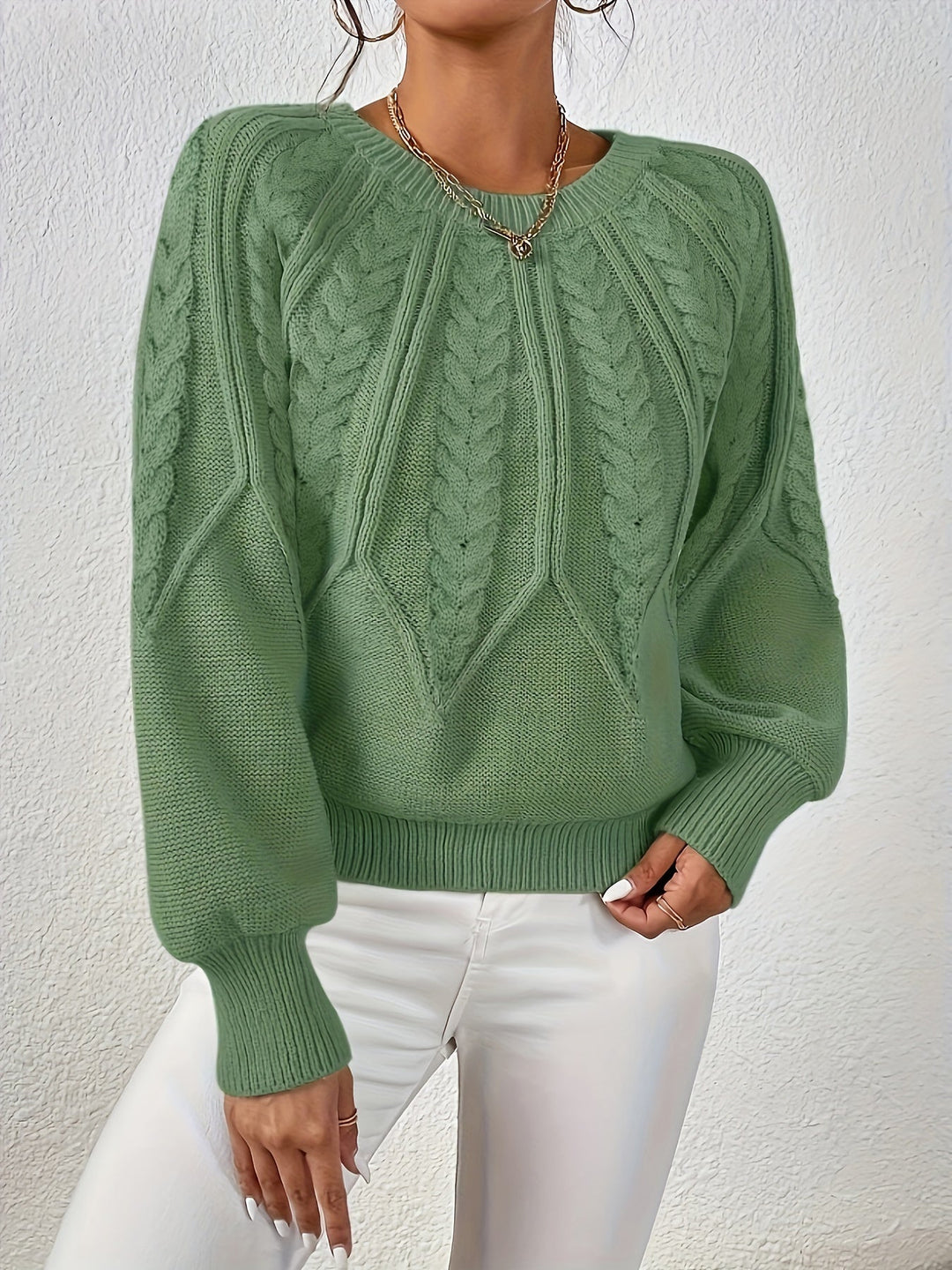 Stylish long sleeve women's cable knit top, relaxed fit, features trendy lantern sleeves.