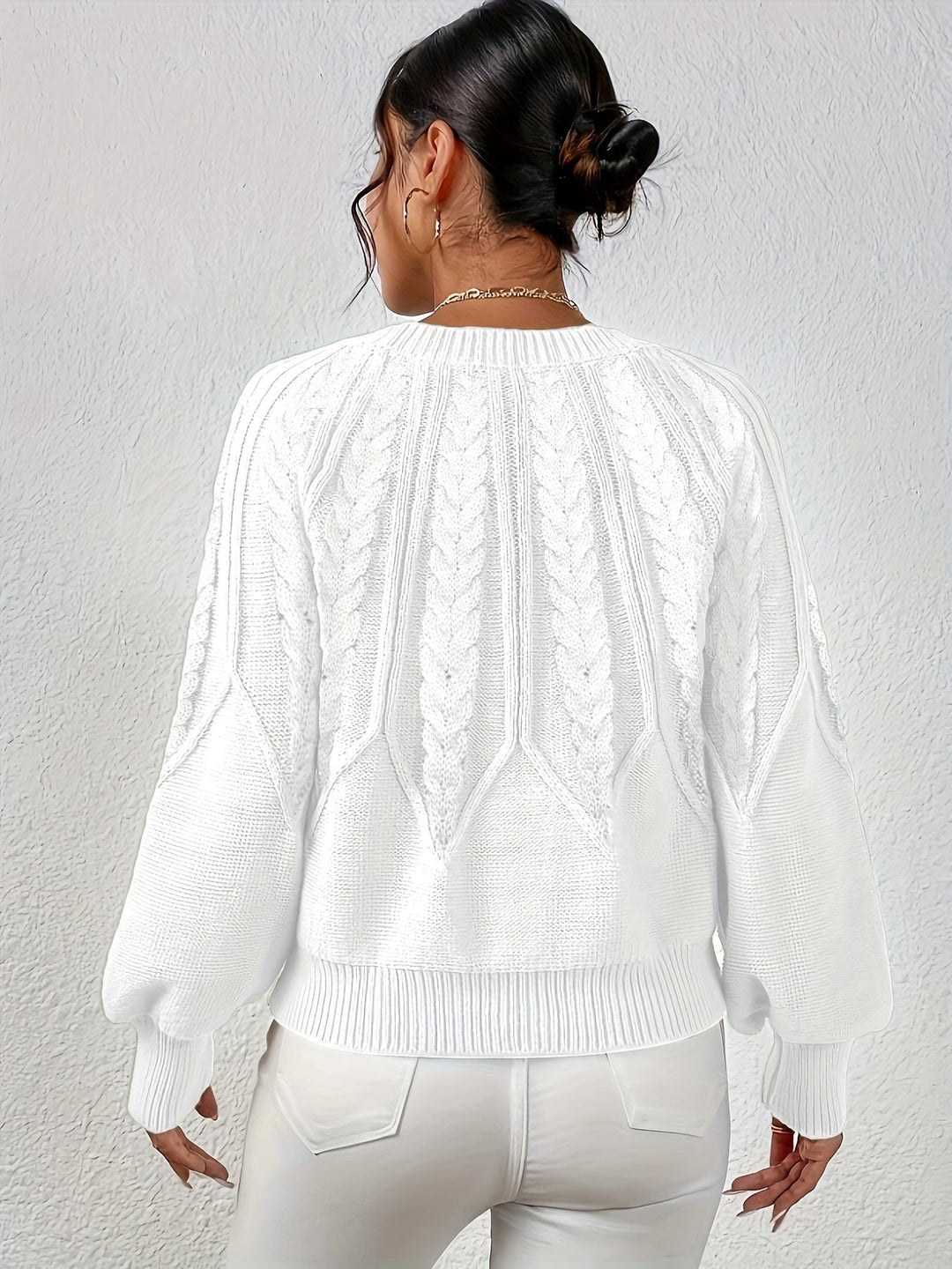 Women's winter staple: cable knit sweater, relaxed fit, elegant lantern sleeves.