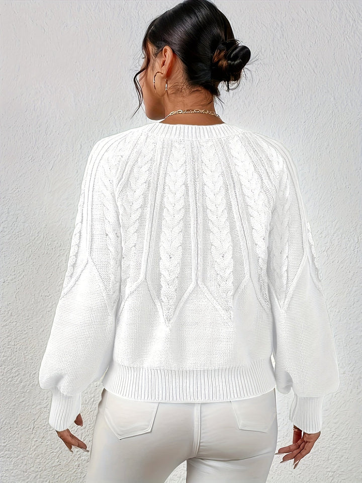 Women's winter staple: cable knit sweater, relaxed fit, elegant lantern sleeves.