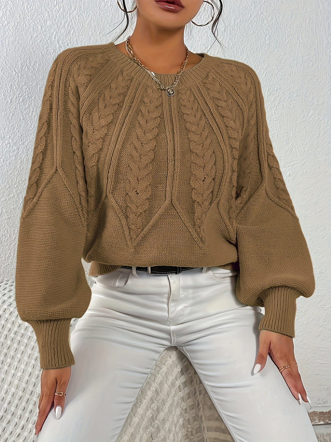 Versatile women's cable knit sweater, relaxed fit, with eye-catching lantern sleeves.
