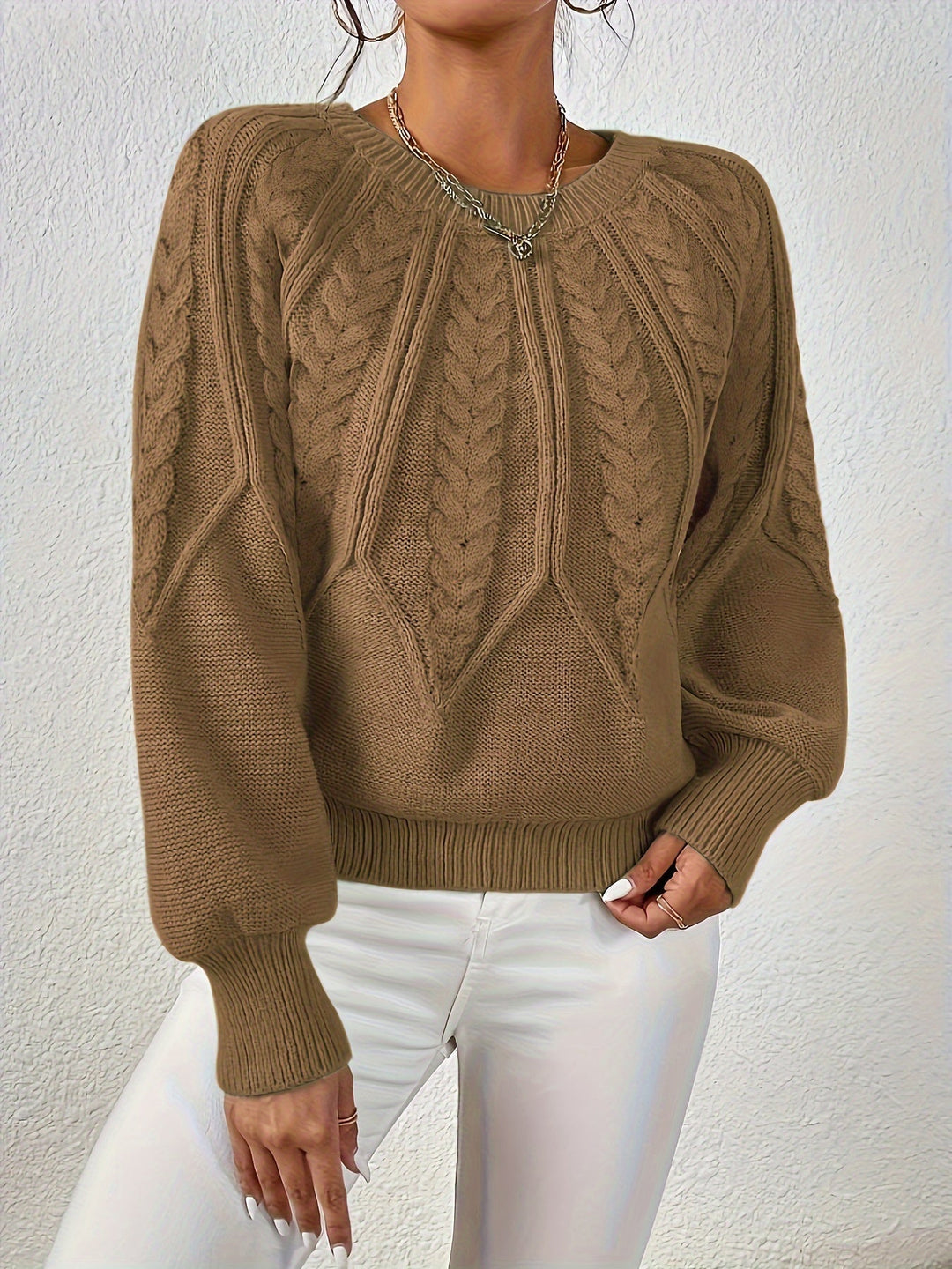 Soft and warm women's cable knit sweater, relaxed fit, elegant lantern sleeves.